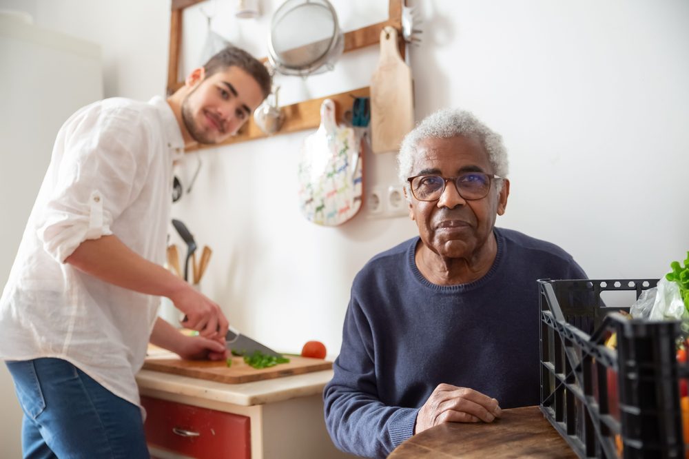 Greater Love and Care caregiver providing cooking together in home kitchen