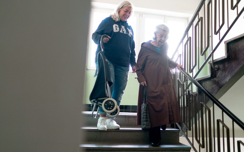 Greater Love and Care caregiver providing caregiver assisting into car / transport