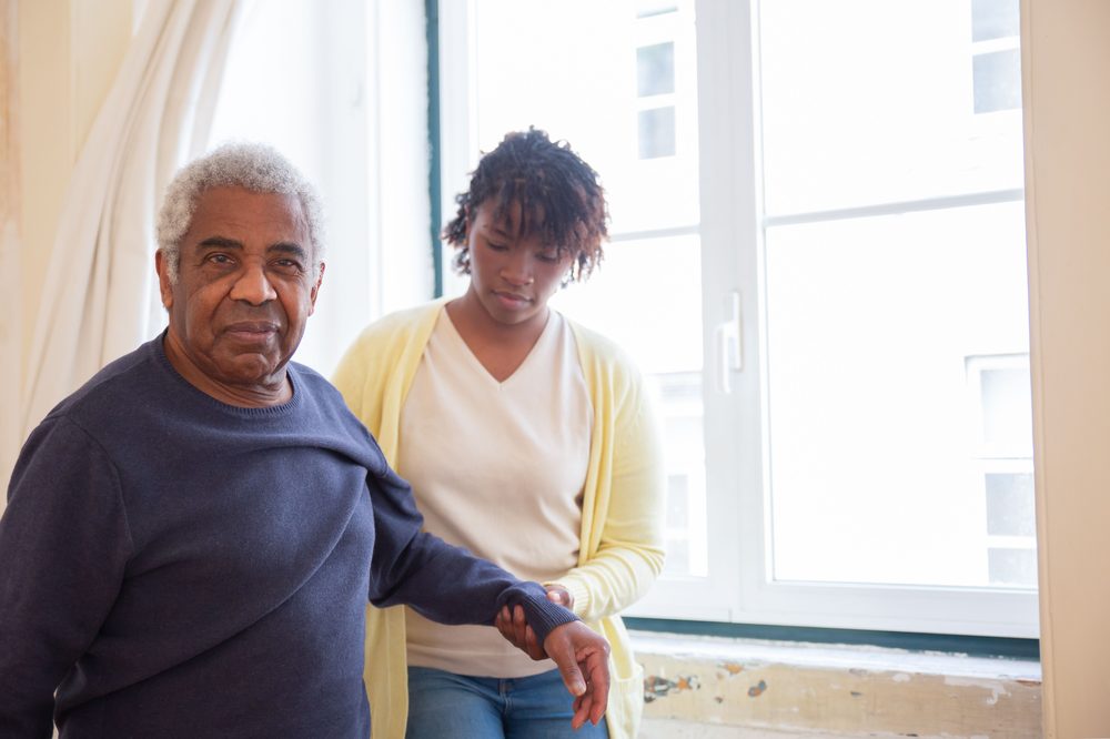 Greater Love and Care caregiver providing gentle grooming / dressing assist